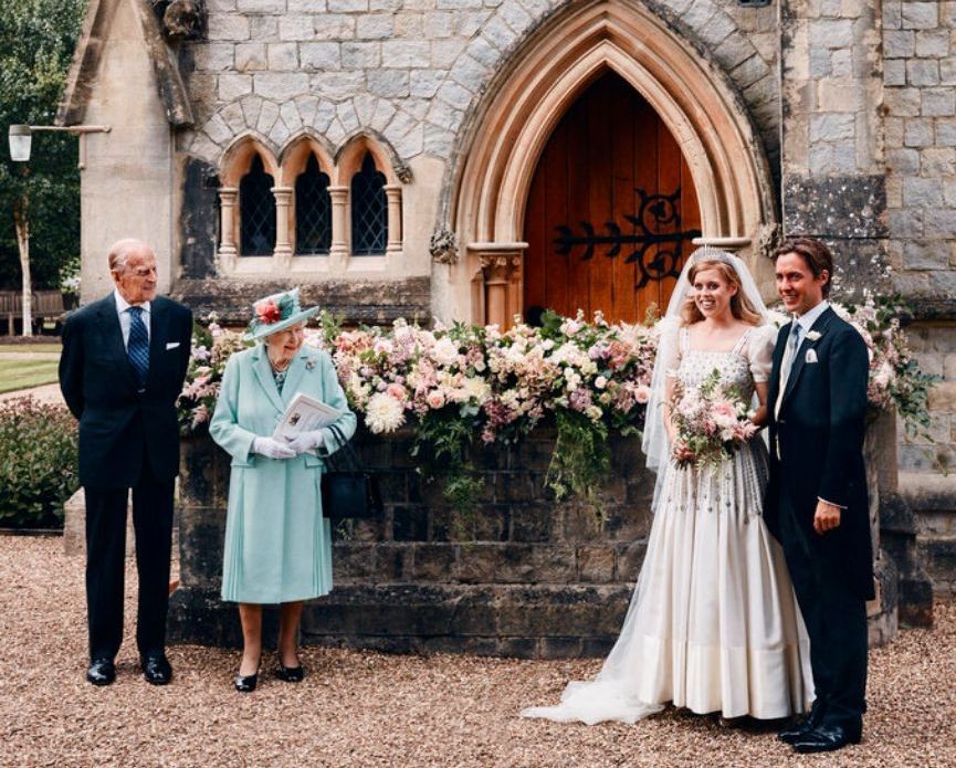In this photograph released by the Royal Communications of Princess Beatrice and Edoardo Mapelli Mozzi, Britain's Queen Elizabeth II and Prince Philip stand alongside Princess Beatrice and Edoardo Mapelli Mozzi outside The Royal Chapel of All Saints at Royal Lodge, Windsor, England, after their wedding. (Benjamin Wheeler/Royal Communications of Princess Beatrice and Edoardo Mapelli Mozzi via AP)